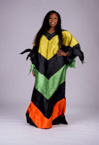 Model wearing The Kaleidoscope color-block boubou in black, yellow, green and orange