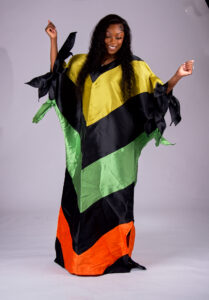 Model wearing The Kaleidoscope color-block boubou in black, yellow, green and orange