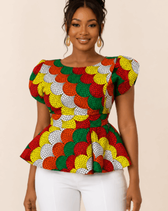 Model wearing The Zuri Radiance Ankara Peplum Blouse with white trousers