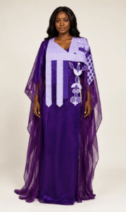 Female model wearing a purple embroidered two-piece boubou